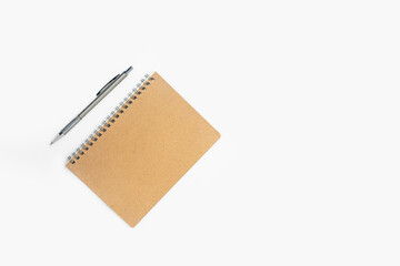 Pen and brown notebook on the desk