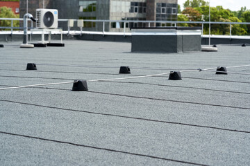 Flat roof protective covering with bitumen membrane for waterproofing - obrazy, fototapety, plakaty