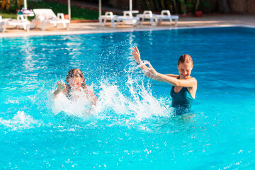 Fototapeta premium Happy beautiful girls having fun at the pool