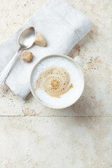 Coffee with milk on bright stone background. Top view. Close up.	