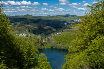 Fototapeta na wymiar The view from the Mäuseberg to the Gemündener Maar in Daun