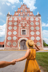 Woman in front of Convent Church of Saint Dominic (Santo Domingo) in Uayma, Yucatan, Mexico