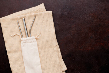 Metal straws on a brown napkin