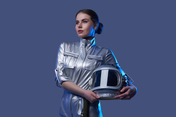 Female space explorer in spacesuit holding helmet © Fxquadro