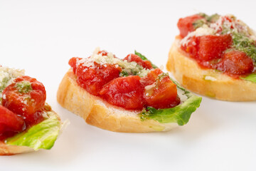 bruschetta with tomatoes, parmesan and pesto sauce. Catering. On a white background