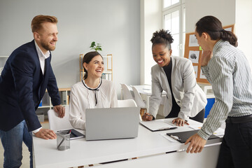 Group of cheerful positive mixed race company coworkers having fun at work. Team of happy creative...