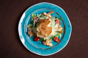 view from above on Greek salad on a blue plate