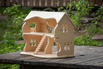 Wooden handcrafted two-story doll house. Waldorf handmade play thing for kids. Natural material toys