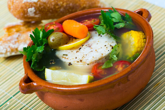 Recipe of pottage of fisherman: boil merluccius head for broth. Add potatoes, carrots, shallots, corn, fish steak 200 g, salt, pepper. Bring to oven, cook for 40min at temperature of 200 deg