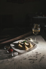 khinkali on a white plate a beautiful foodphoto. dish in restaurant