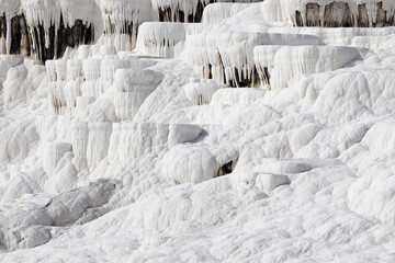 Close up of white limestone natural travertine terraces in pamukkale with pools full of carbonated water