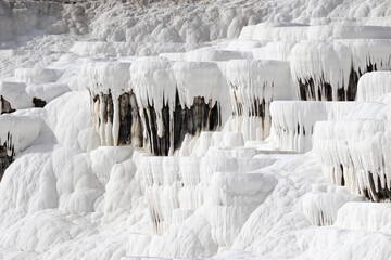 Close up of white limestone natural travertine terraces in pamukkale with pools full of carbonated water