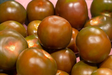 Black juicy tomato. Vegetables close-up