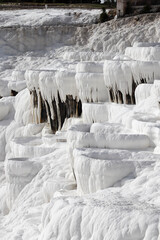 Close up of white limestone natural travertine terraces in pamukkale with pools full of carbonated water