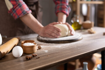 Baker man making dough and bakery ingredients for homemade bread cooking on table. Bakery concept