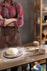 Baker man making dough and bakery ingredients for homemade bread cooking on table
