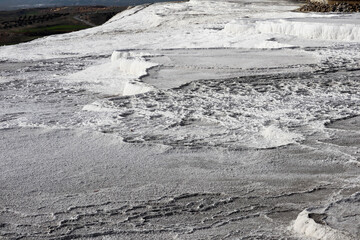 beautiful white fields of carbonated limestone formations in Pamukkale, Turkey