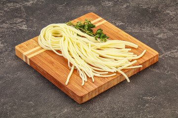 Chechil spaghetti cheese over board