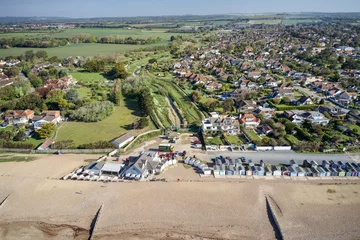 Foto auf Alu-Dibond Ferring seafront on the English Channel with the Ferring Rife running next to the village of Ferring and towards the Beach Huts and coastline. Aerial view. © Geoff