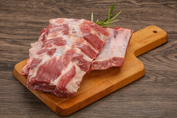 Raw pork ribs served rosemary