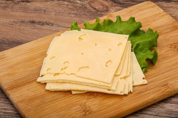 Sliced yellow cheese over board