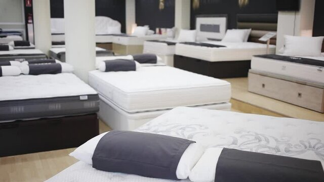 Image of new modern mattresses on the beds in the mattress store 