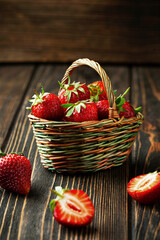 Sweet fresh strawberries in a basket on a wooden table - 436391608