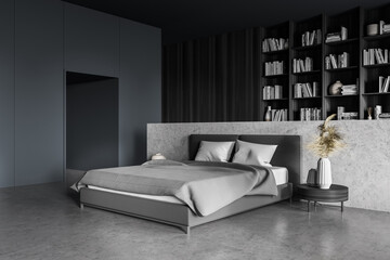 Dark bedroom interior, grey bed with linens and coffee table, bookshelf on background © ImageFlow