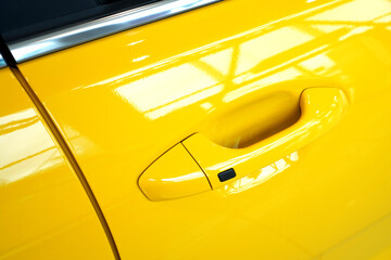 Keyless access entry button with touch sensor on a car handle.