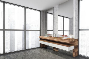 Modern design bathroom interior with double sink countertop, bronze faucets. Panoramic window with skyscrapers city view. Wood and concrete materials. Public wc hands wash concept.