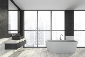 Fototapeta na wymiar Modern design bathroom interior with white oval bathtub, black sink, countertop, silver faucets. Panoramic window with skyscrapers city view. Wooden and concrete materials.