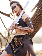 Beautiful amazon woman posing with sword