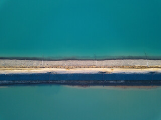Abstract top down view of a large turquoise salt lake 