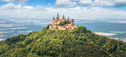 Hohenzollern Castle on mountain top, Germany. Panoramic view of German burg like palace. - obrazy, fototapety, plakaty