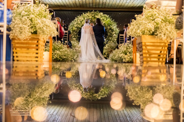 groom and bride from the back at the wedding ceremony