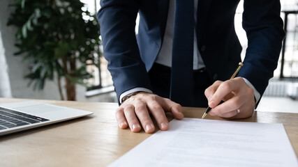 Company executive, business owner, employer signing contract, agreement, paper report at workplace....