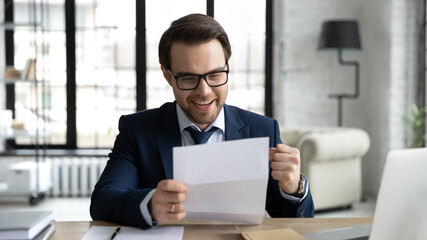 Fototapeta na wymiar Happy businessman learning good news, reading letter, getting document from bank with approval loan or mortgage, receiving insurance notice, professional certificate. Paperwork, correspondence concept