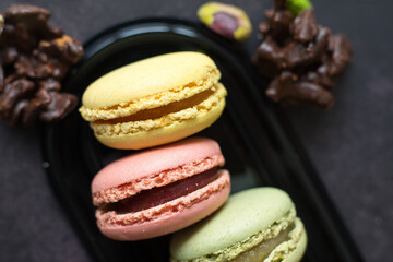 Colorful macarons and pistachios isolated. French meringue cookie macaron.