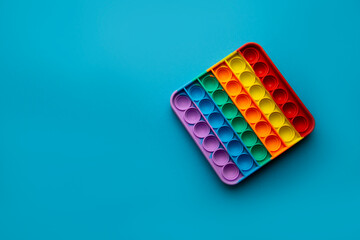 Sensory color trendy pop it stress reliever toy isolated on blue background