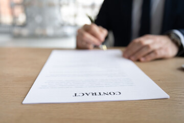 Hands of business leader, employer sitting at table, signing contract, job agreement, hiring...