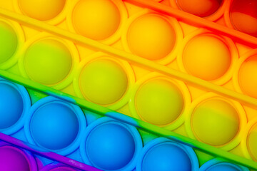 Close up view of the sensory toy pop it with Rainbow color.