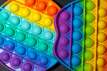 Colorful anti stress silicone sensors toy for children on black background.