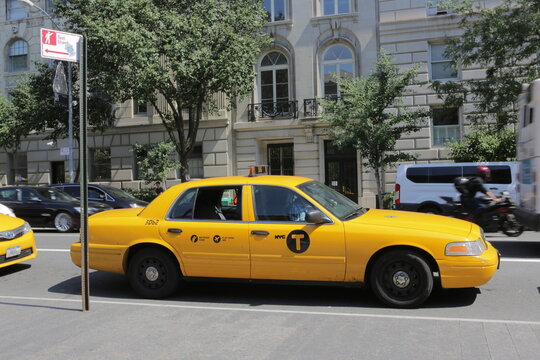 New York City, NY, USA 2.09.2020 - Yellow cab waiting on taxi stand in Manhattan. Metered fare, flat JFK fare. NYC taxi. Yellow cab cars are recognizable symbol of New York City