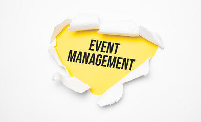 Top view of white torn paper and the text Event Management on a yellow background.