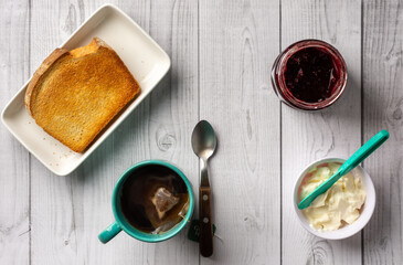 bread with butter, tea and blueberry jam