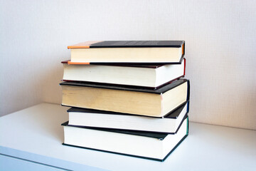 Education and reading concept - group of colorful books on the wooden table