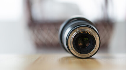 The lens mount ass is placed on the table with a blurred background.