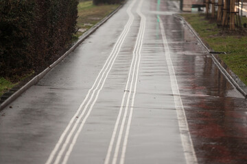 Selective blur on a tactile walking surface indicator white track on pedestrian sidewalk in urban environment. Also called ground surface indicators, it's used to help blind  visually impaired people