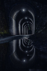 Dark tunnel with water reflections