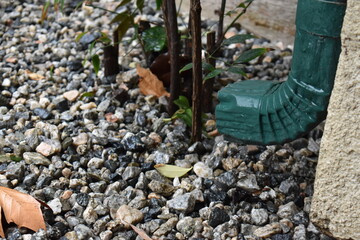 drain over rocks in the rain